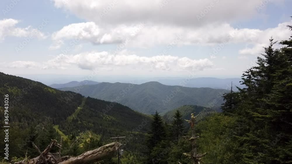Time lapse: scenic green hillside landscape view of blue ridge mountain ranges, vegetation, trees and foliage with white cumulus and stratus clouds rolling over summit, static Time lapse: scenic green hillside landscape view of blue ridge mountain ranges, vegetation, trees and foliage with white cumulus and stratus clouds rolling over summit, static