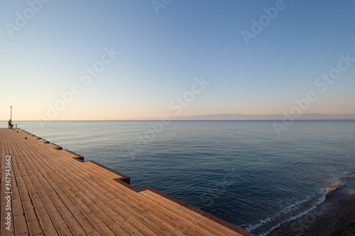 Fototapeta Naklejka Na Ścianę i Meble -  Sea Pier in the early morning (oblique view to horizon)