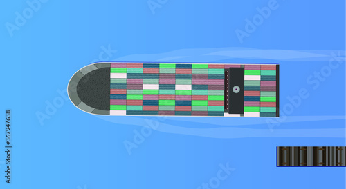 Cargo ship leaving a jetty carrying a full load of shipping containers. Boat driving away from a harbour