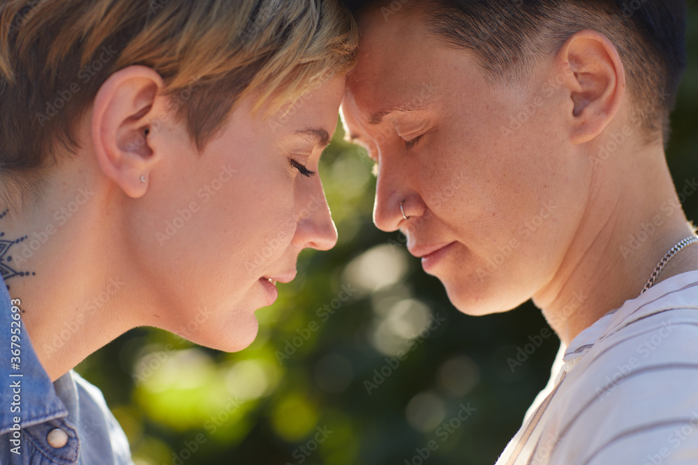 Close-up of two young women standing face to face with their eyes closed and enjoying each other Close-up of two young women standing face to face with their eyes closed and enjoying each other