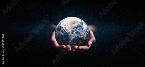Fototapeta Naklejka Na Ścianę i Meble -  earth in hands on space. green planet on hand. save of earth. environment concept for background web or world guardian organization.Elements of this image furnished by NASA