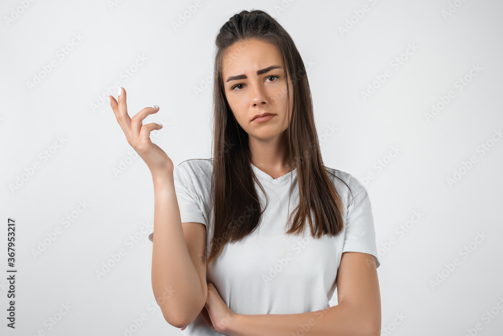 What the hell are you talking about, nonsense. Studio shot of frustrated female with long chestnut hair gesturing with raised palm, frowning, being displeased and confused with dumb question. What the hell are you talking about, nonsense. Studio shot of frustrated female with long chestnut hair gesturing with raised palm, frowning, being displeased and confused with dumb question.