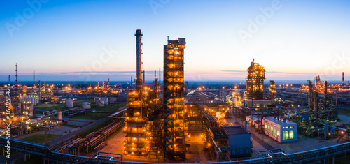 Oil refinery plant industry  Refinery factory. oil storage tank  rectification column and pipeline against the backdrop of sunset in summer  Russia.