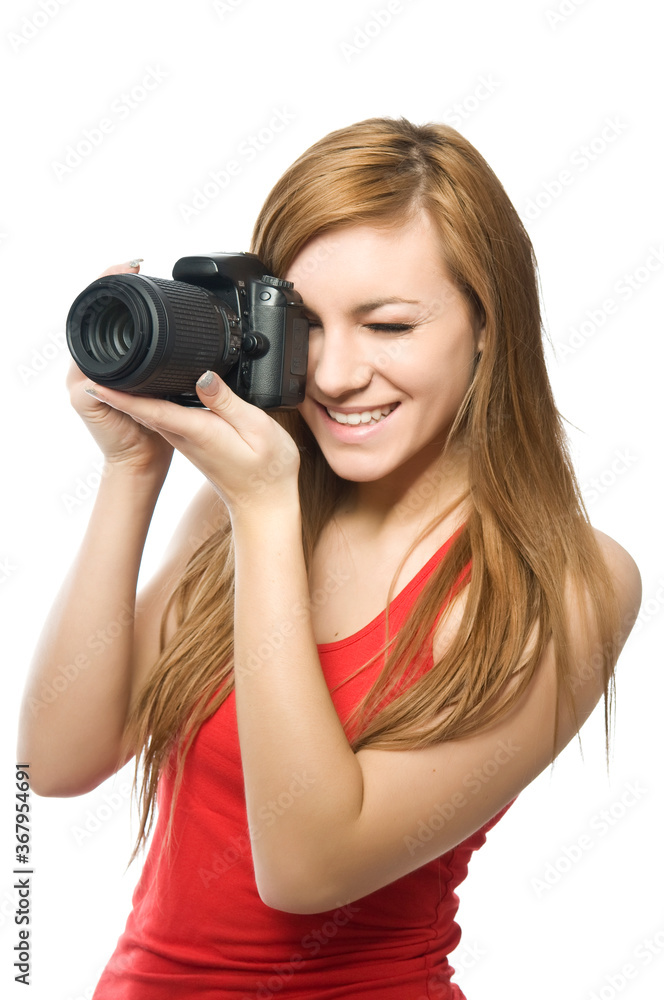 Photography is fun! Young beautiful woman photographer taking images with digital camera and smiling. Isolated on white Photography is fun! Young beautiful woman photographer taking images with digital camera and smiling. Isolated on white