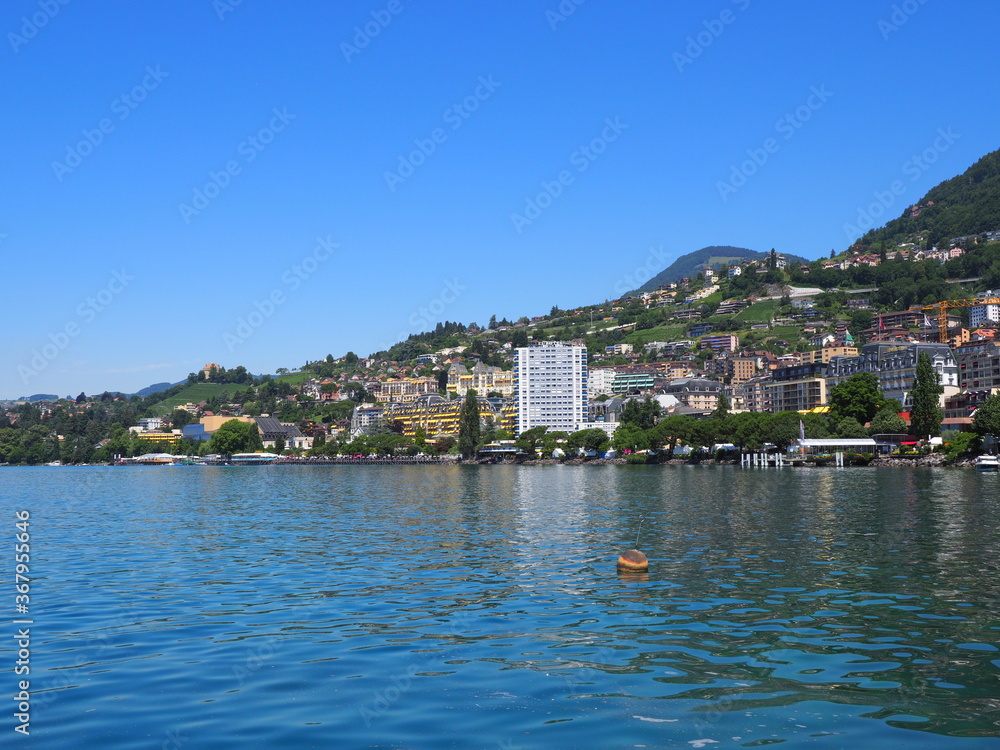 View to Lake Geneva and european Montreux city in canton Vaud in Switzerland, clear blue sky in 2017 warm sunny summer day on July.