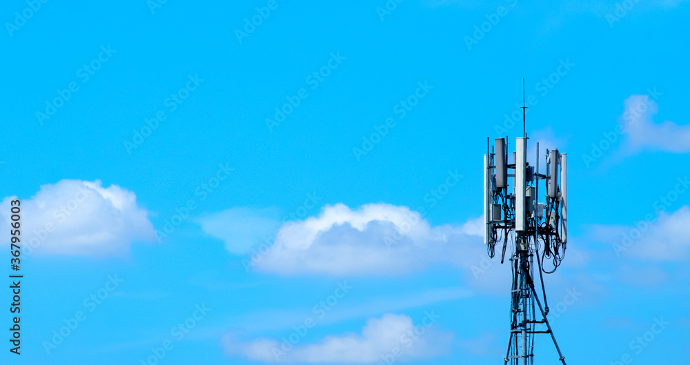 Horizontal of communication tower with cloudy and blue sky with space for text. Concept for mobile communication, signal transmitter broadcasting and tower antenna construction for signal.