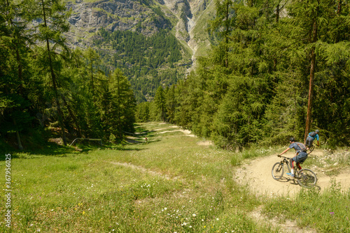 People driving a mtb on a flow trail at Zermatt on the Swiss alps