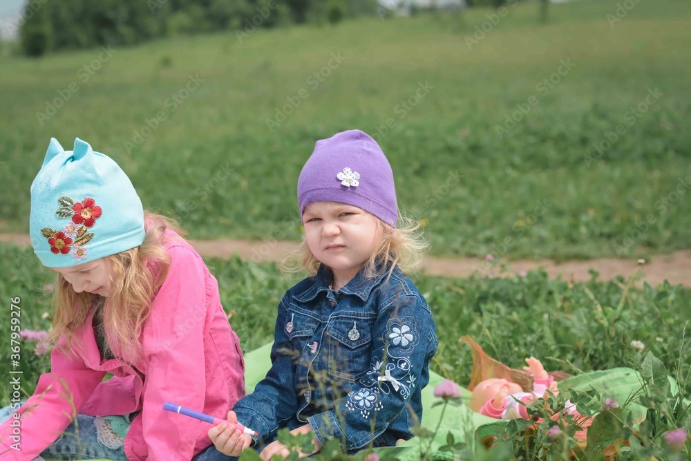 Two sisters laughing and playing in the park