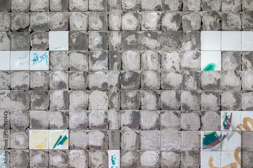 Concrete wall background with stains of peeled off old tile