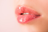 Natural beauty lip care. Female lips with pink lipstick. Sensual tenderness womens open mouths. Red lip with glossy lipgloss. Close up, macro with beautiful mouths. Sensual lips of a young woman.