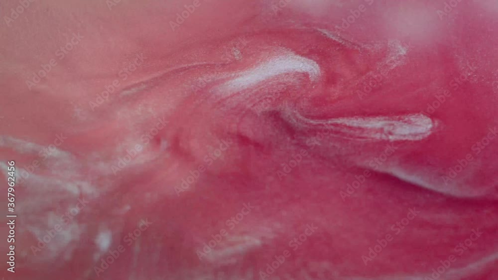 Abstract liquid pink background. Surface with a moving flow of paint, creative drops of color Abstract liquid pink background. Surface with a moving flow of paint, creative drops of color