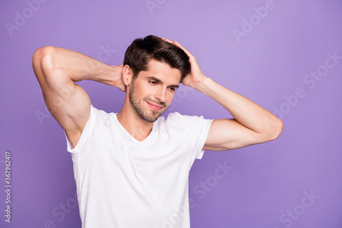 Close-up portrait of his he nice attractive content cheery dreamy brown-haired guy touching soft silky hair isolated over bright vivid shine vibrant lilac violet purple color background