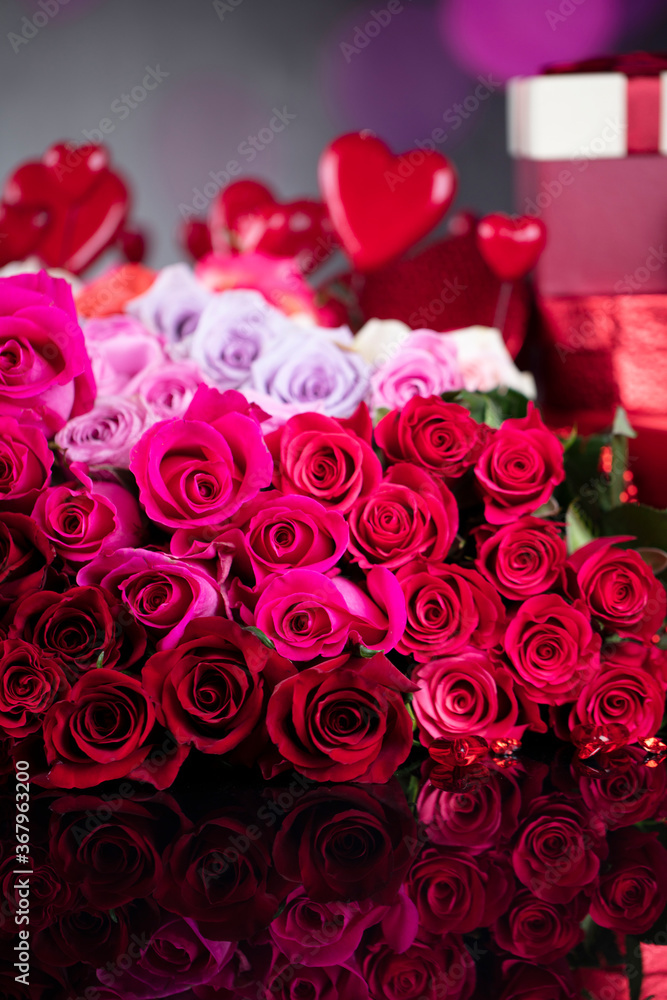Wedding day concept. Big bouquet of roses and boxes with wedding gifts on glass table. Wedding day concept. Big bouquet of roses and boxes with wedding gifts on glass table.