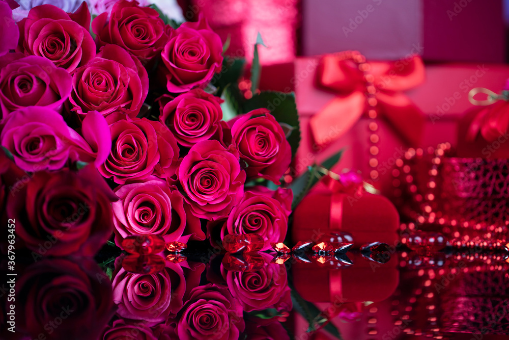 Wedding day concept. Big bouquet of roses and boxes with wedding gifts on glass table. Wedding day concept. Big bouquet of roses and boxes with wedding gifts on glass table.