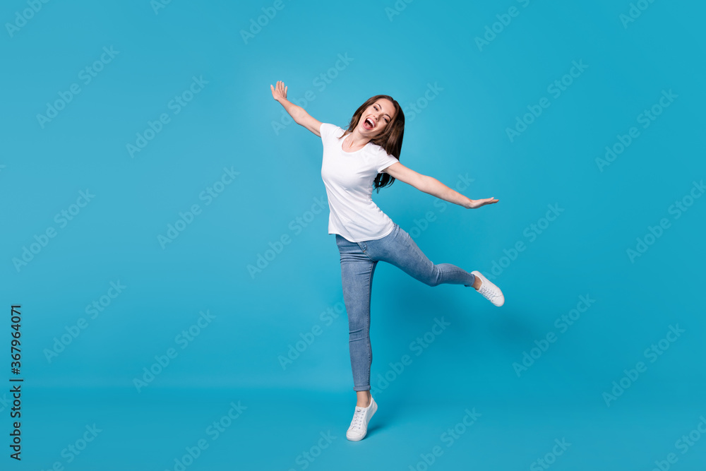Full length body size view of her she attractive pretty careless funky slim skinny glad cheerful cheery girl jumping fooling having fun isolated bright vivid shine vibrant blue color background