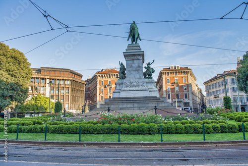 MILAN, ITALY - SEPTEMBER 2015: Tourists on square Largo Cairoli near Monument to Giuseppe Garibaldi in Milan photo