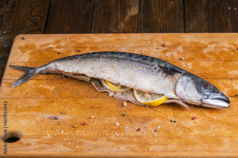 Raw mackerel stuffed lemon on wooden board Raw mackerel stuffed lemon on wooden board