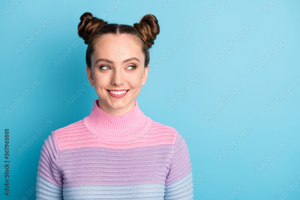 Closeup photo of attractive teen lady two funny buns good mood toothy smile charming cute nice youngster look side empty space wear casual warm sweater isolated blue color background Closeup photo of attractive teen lady two funny buns good mood toothy smile charming cute nice youngster look side empty space wear casual warm sweater isolated blue color background