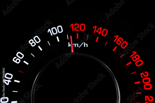 Close up shot of a red speedometer in a car. Car dashboard. Dashboard details with indication lamps.Car instrument panel. Dashboard with speedometer, tachometer, odometer. Car detailing.