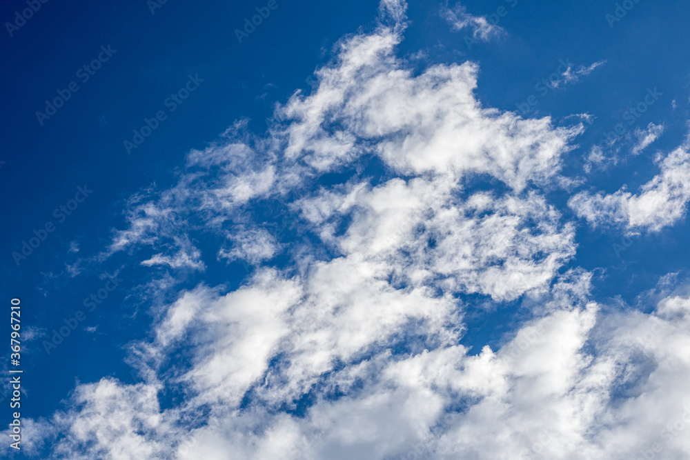 Obraz premium Clear blue sky with white clouds.