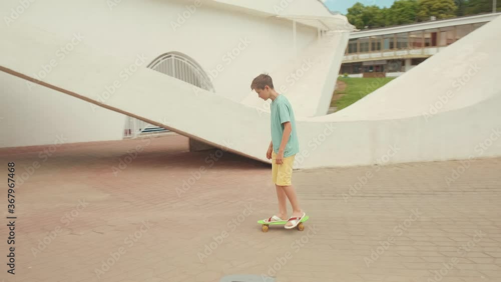 Handsome young guy is riding a skateboard. Sunny weather. Handsome young guy is riding a skateboard. Sunny weather.