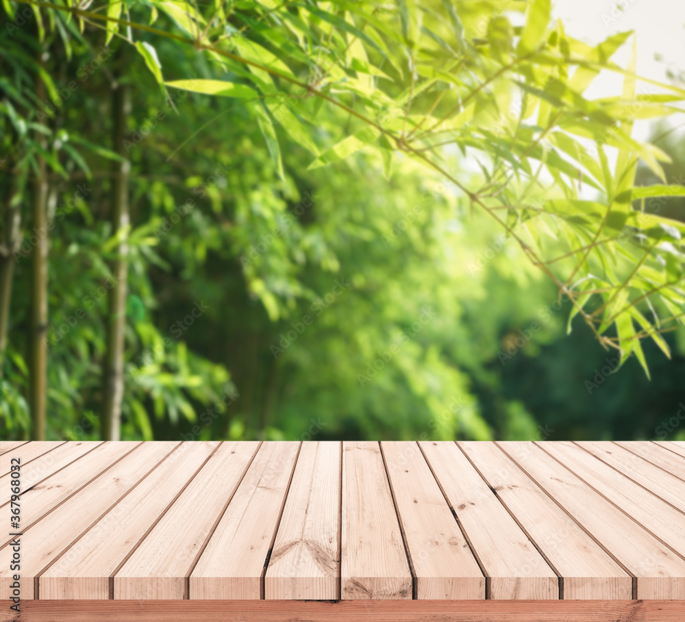 Wood plank with abstract natural blurred bamboo forest and bokeh background for product display