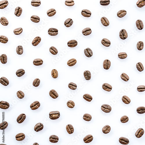 Pattern of roasted coffee beans arrange on white background