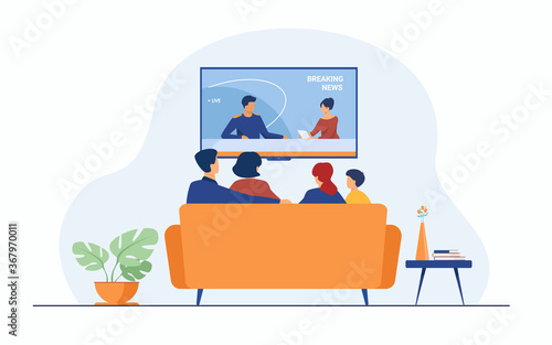 Breaking news concept. Back view of family couple and children sitting on sofa in living room, watching TV news with host interviewing guest. For television, broadcasting, media production concepts
