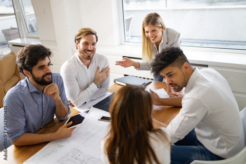 Group of business people meeting in office, sharing their ideas. Group of business people meeting in office, sharing their ideas.