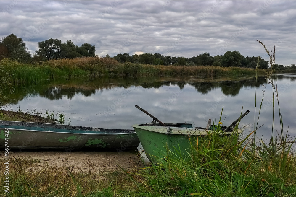 Lake with a wooden bridge and green grass.