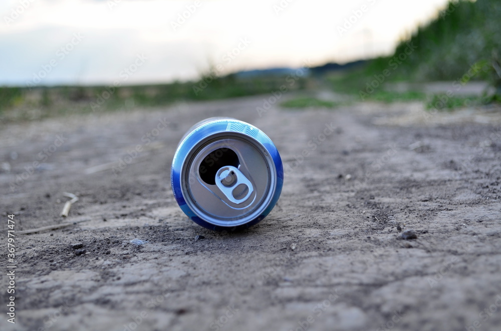 Aluminium blue can on the ground