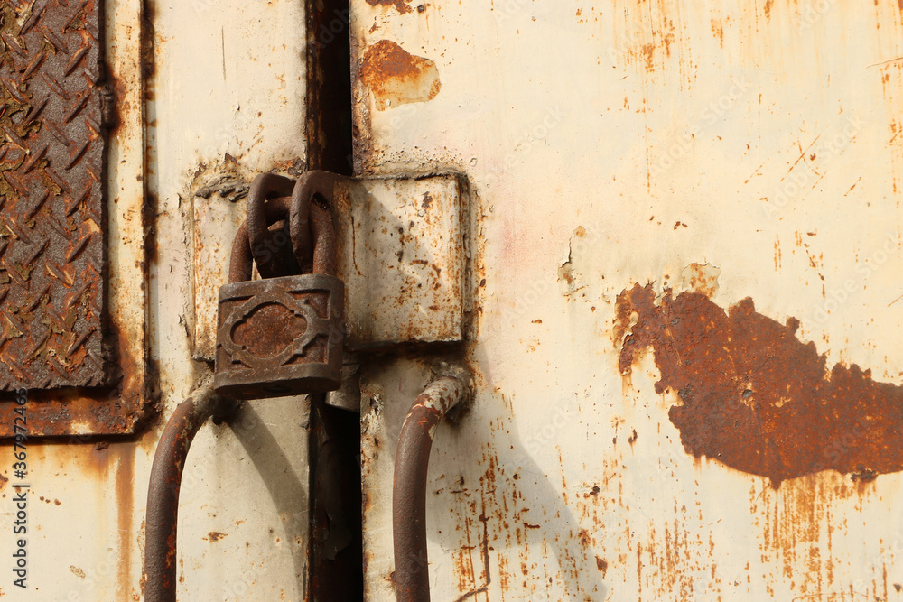 Old padlock on rusty iron door. Old rusty key lock steel door. Old locked door.. Old padlock on rusty iron door. Old rusty key lock steel door. Old locked door..