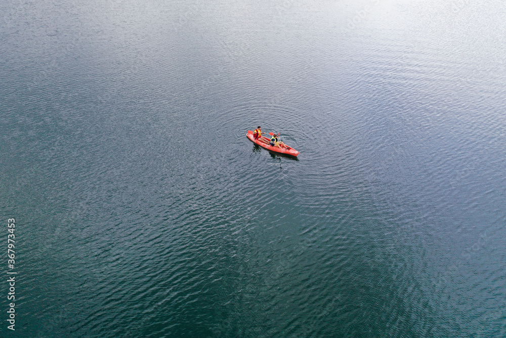 Fototapeta premium Kayak floats on the river view from the top, from the drone, two guys in the canoe