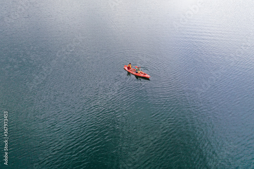 Kayak floats on the river view from the top, from the drone, two guys in the canoe