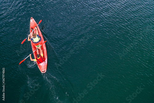 Kayak floats on the river view from the top, from the drone, two guys in the canoe