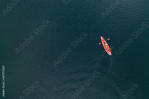 Kayak floats on the river view from the top  from the drone  two guys in the canoe