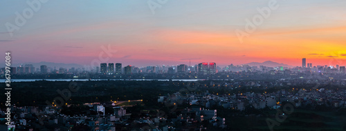 Panorama cityscape of Hanoi skyline at Vinh Tuy bridge over Red river during sunset time