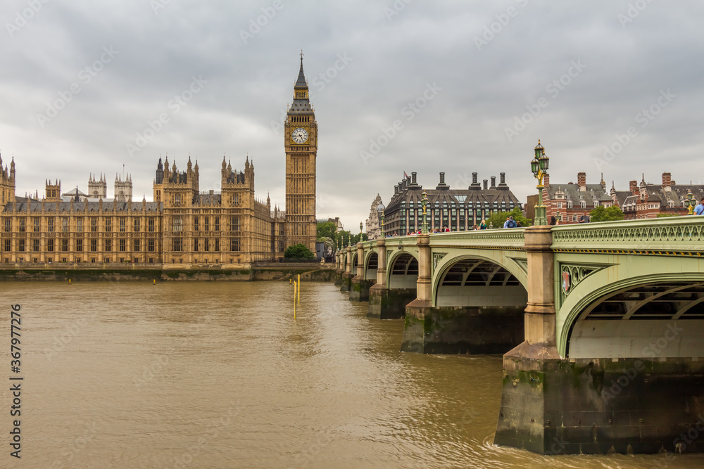 Big Ben by Westminster Bridge and the River Thames on a cloudy day in London