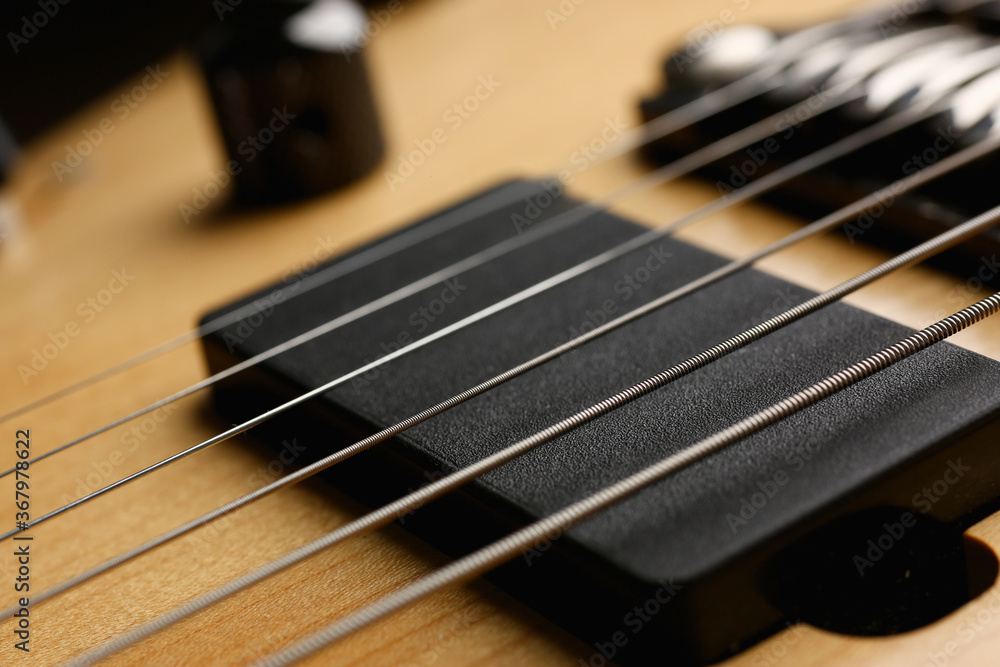 Classic shape wooden electric guitar with rosewood neck closeup. Six stringed learning lesson musician school education art leisure electrical vintage stage wood guitar concept Classic shape wooden electric guitar with rosewood neck closeup. Six stringed learning lesson musician school education art leisure electrical vintage stage wood guitar concept