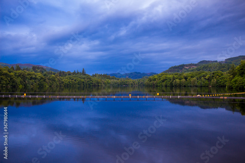 A view of Loch Faskally from the Pitlochry Dam wall at sunset, with a reflection © Jozef
