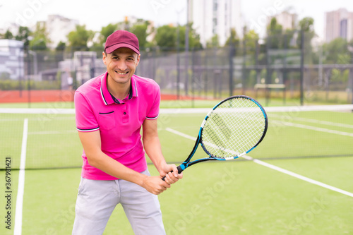 Male tennis player at the court looking happy © Angelov