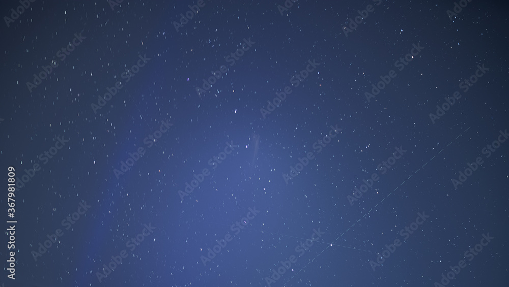 Star with satellite trail - night sky background.