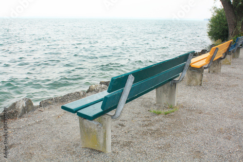 Obraz na płótnie Blue and Yellow benches on the lake side in Switzerland. w salonie
