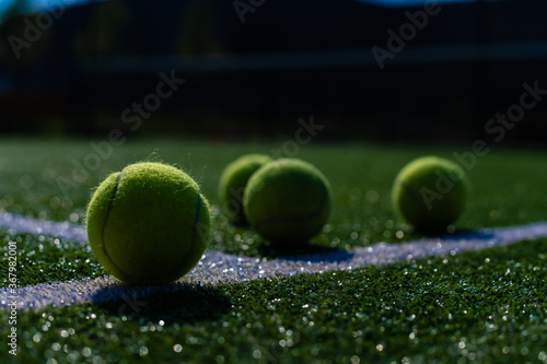 View of empty lawn tennis court with tennis ball © Angelov