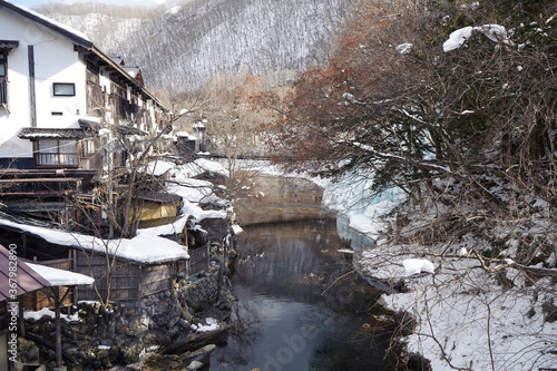 Japanese Onsen next to river in snowy forest, Nikko