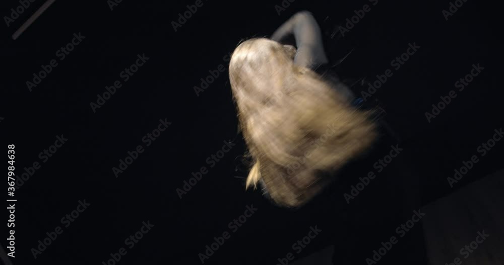 Young female dancer is practicing in the gym, dancing in the dark, 4k Young female dancer is practicing in the gym, dancing in the dark, 4k