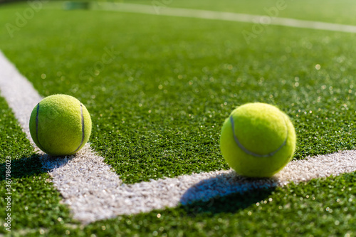 View of empty lawn tennis court with tennis ball © Angelov