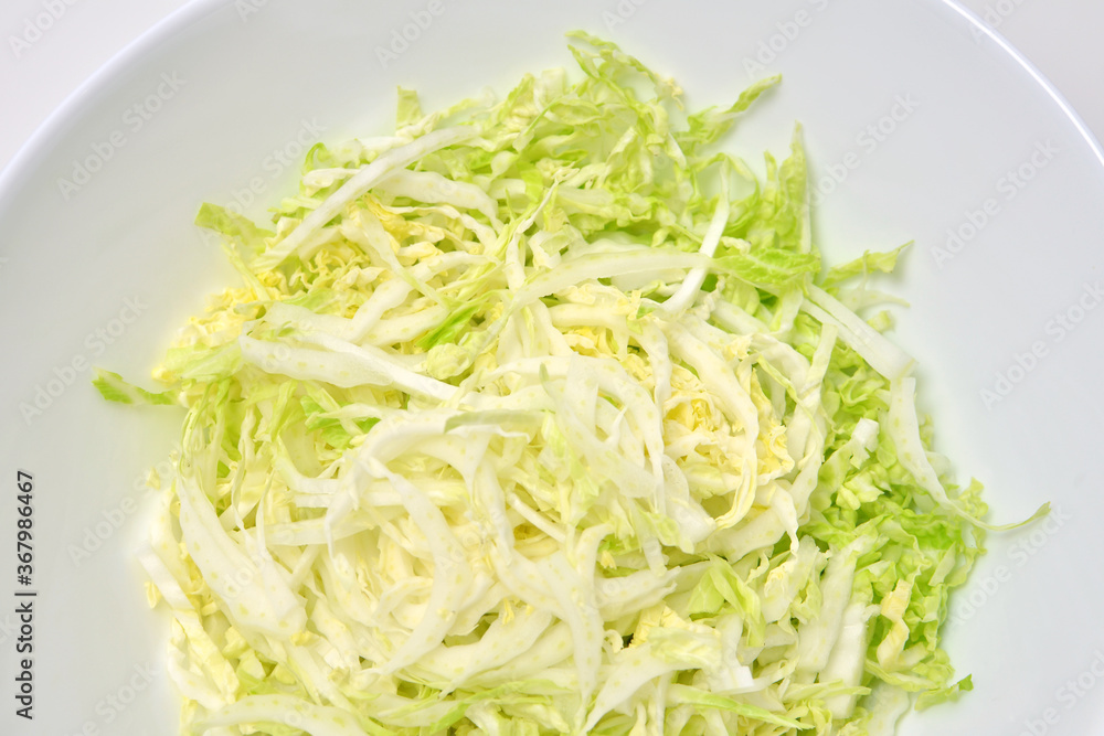 Chinese cabbage salad on white background. Vegan food. Chinese cabbage salad on white background. Vegan food.
