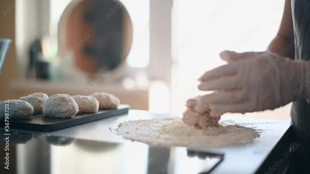 Preparing raw meat cutlets in a flour. Hands cook in latex cooking gloves. Preparing raw meat cutlets in a flour. Hands cook in latex cooking gloves.