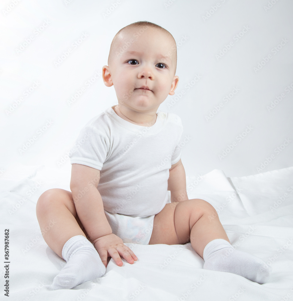 Image of a sitting nine-month-old boy on a white background Image of a sitting nine-month-old boy on a white background